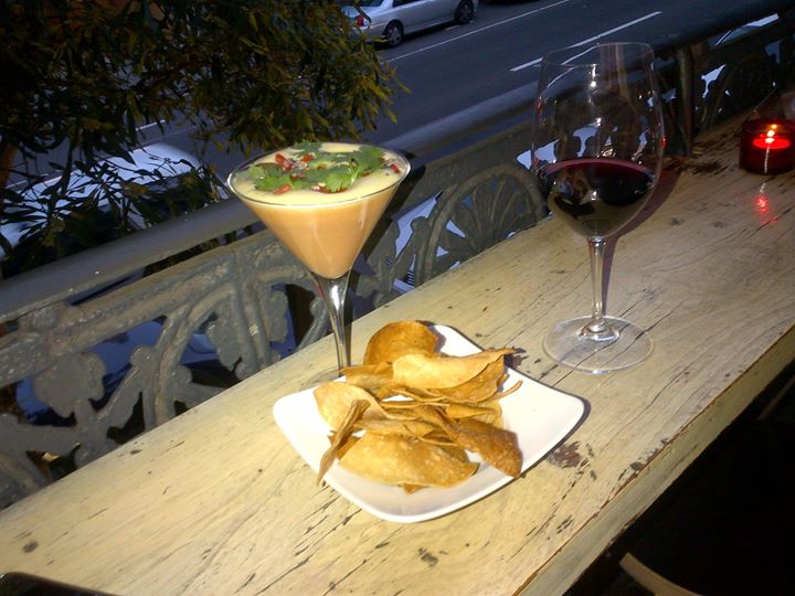 Nacho's cheese fondue with a glass of sangiovese merlot